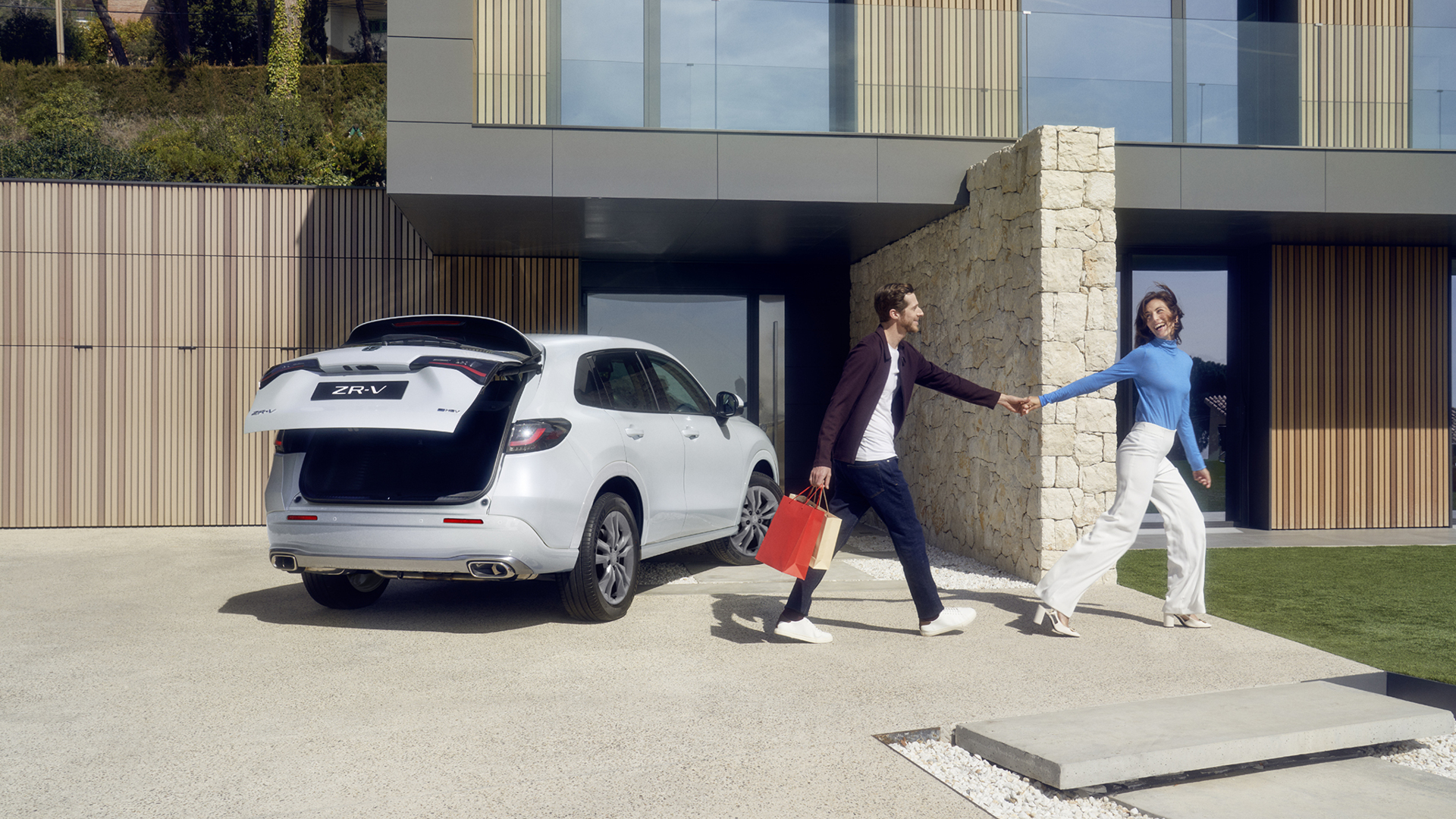 White ZR-V in driveway with power tailgate