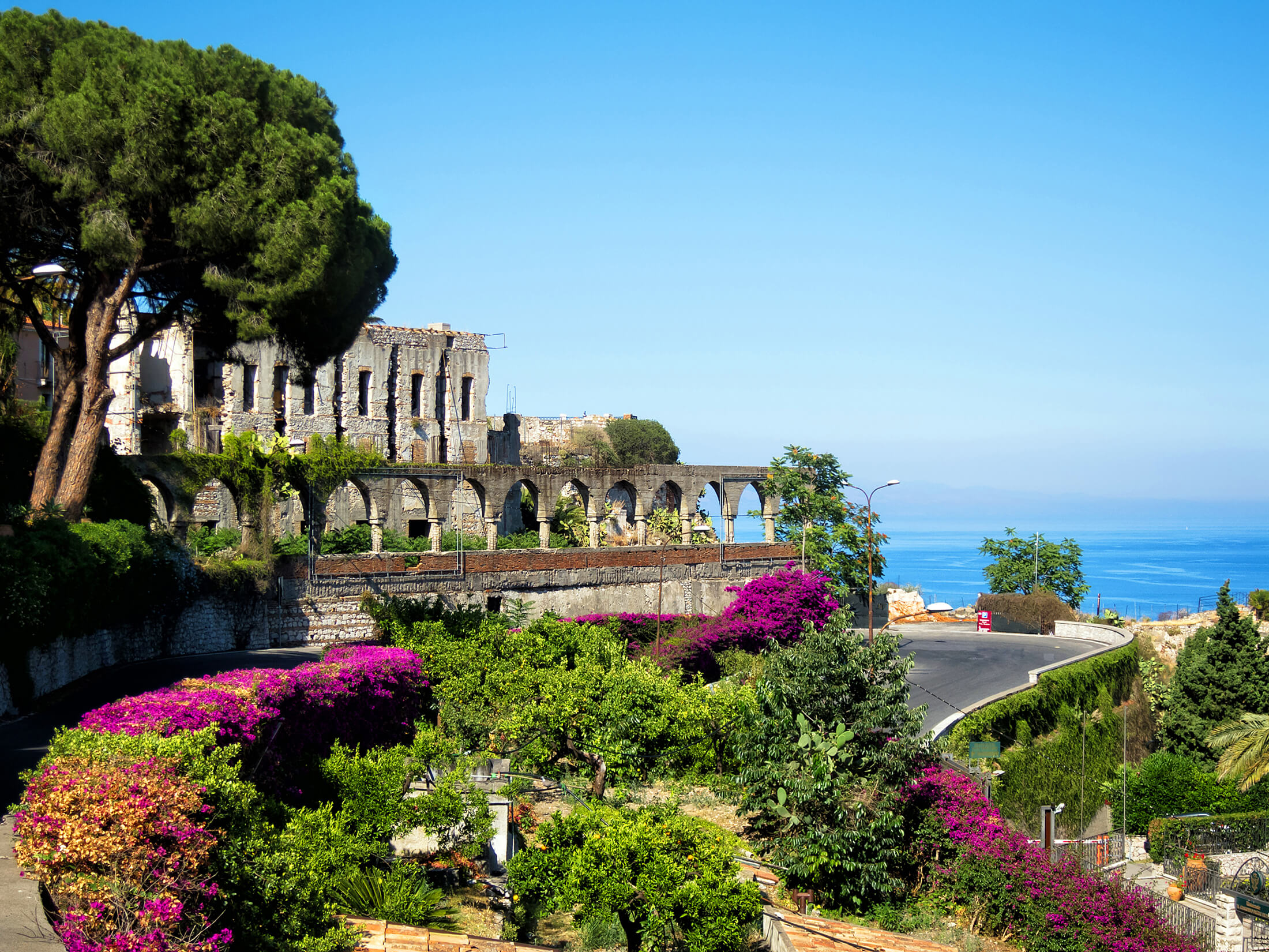 A colourful garden near an old building on Sicily, Italy