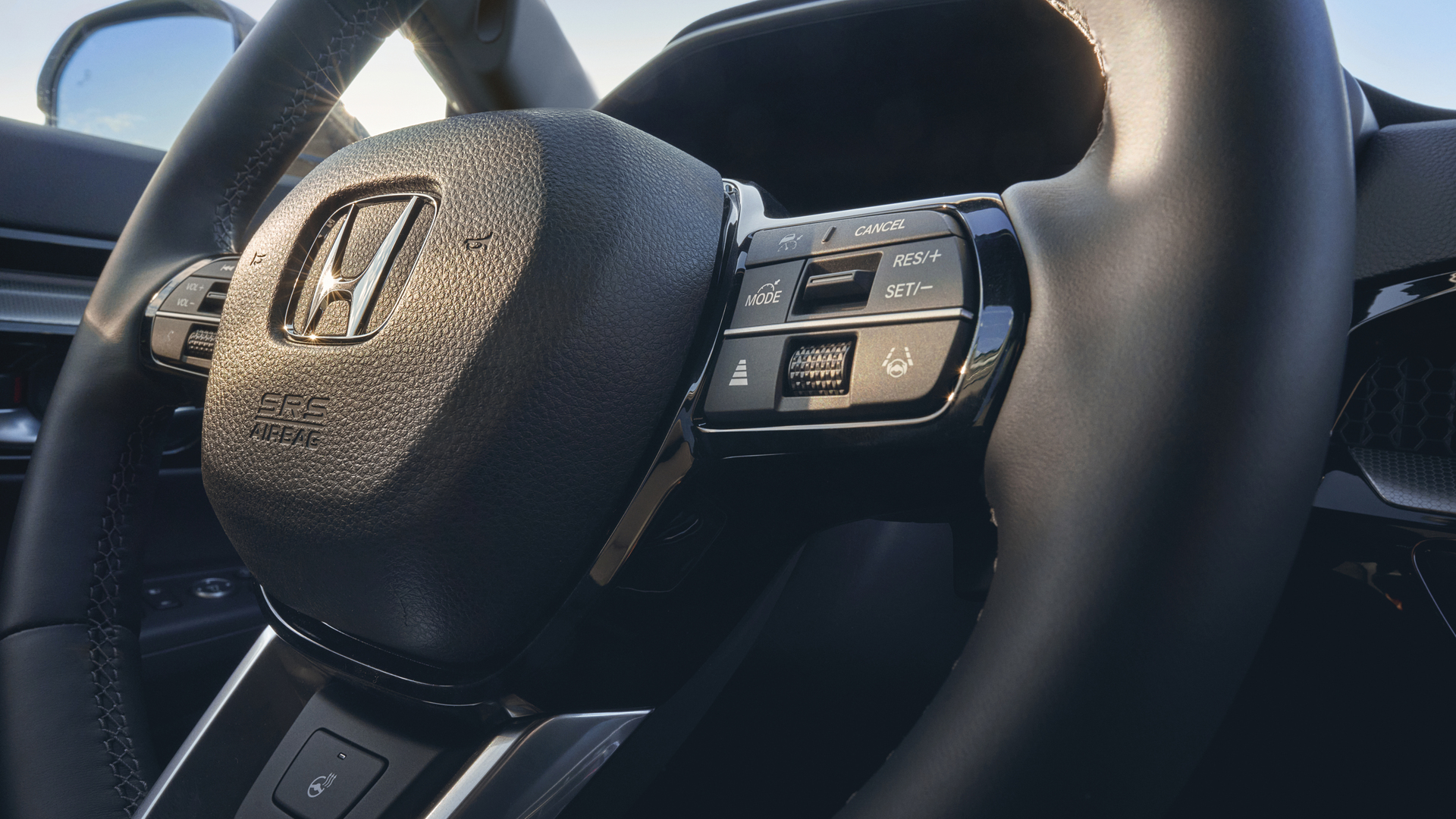 Close-up van het verwarmde lederen stuurwiel van de Honda CR-V Hybrid.