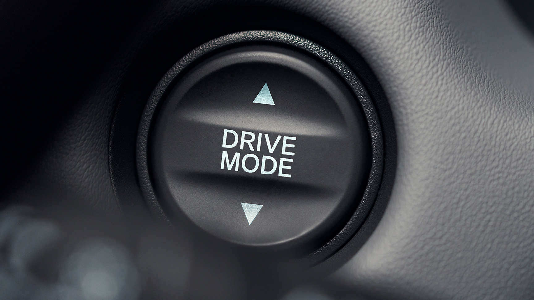 Close up of drive mode button with white text