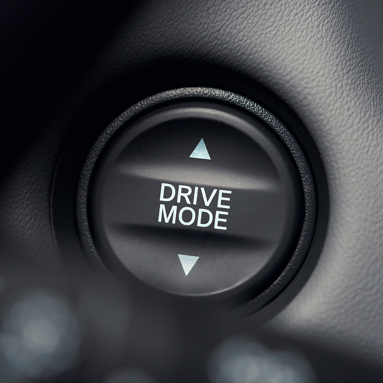 Close up of drive mode button with white text