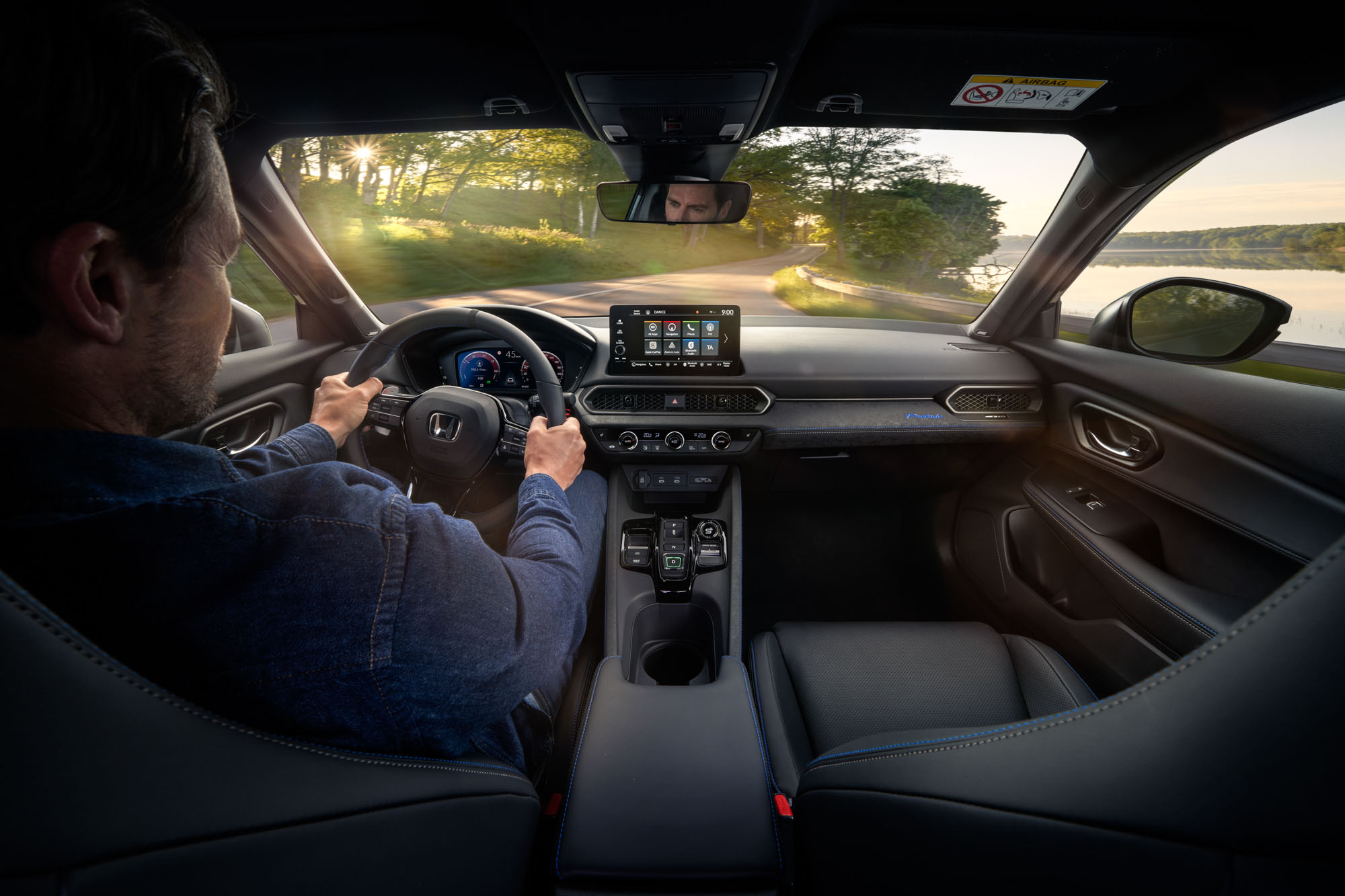 De bestuurder geniet van het interieur van de Honda Prelude Hybrid met digitale cockpit en geavanceerd infotainment.