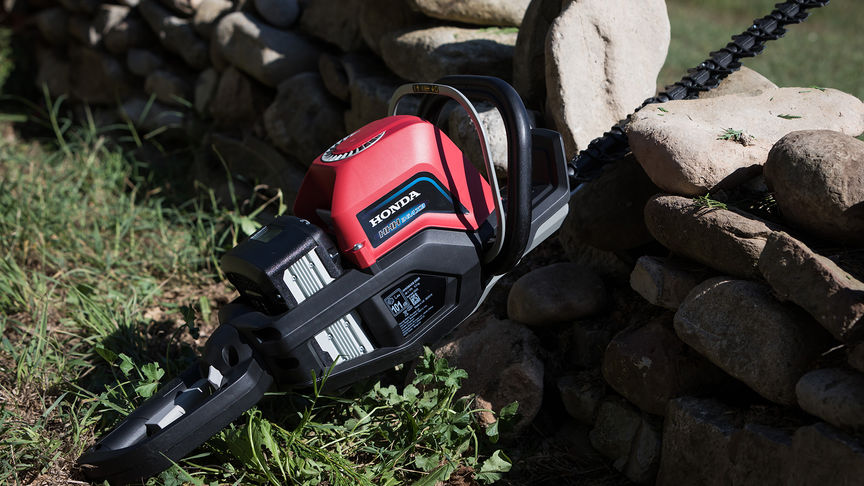 Close up of Honda's cordless hedge trimmer in garden location.