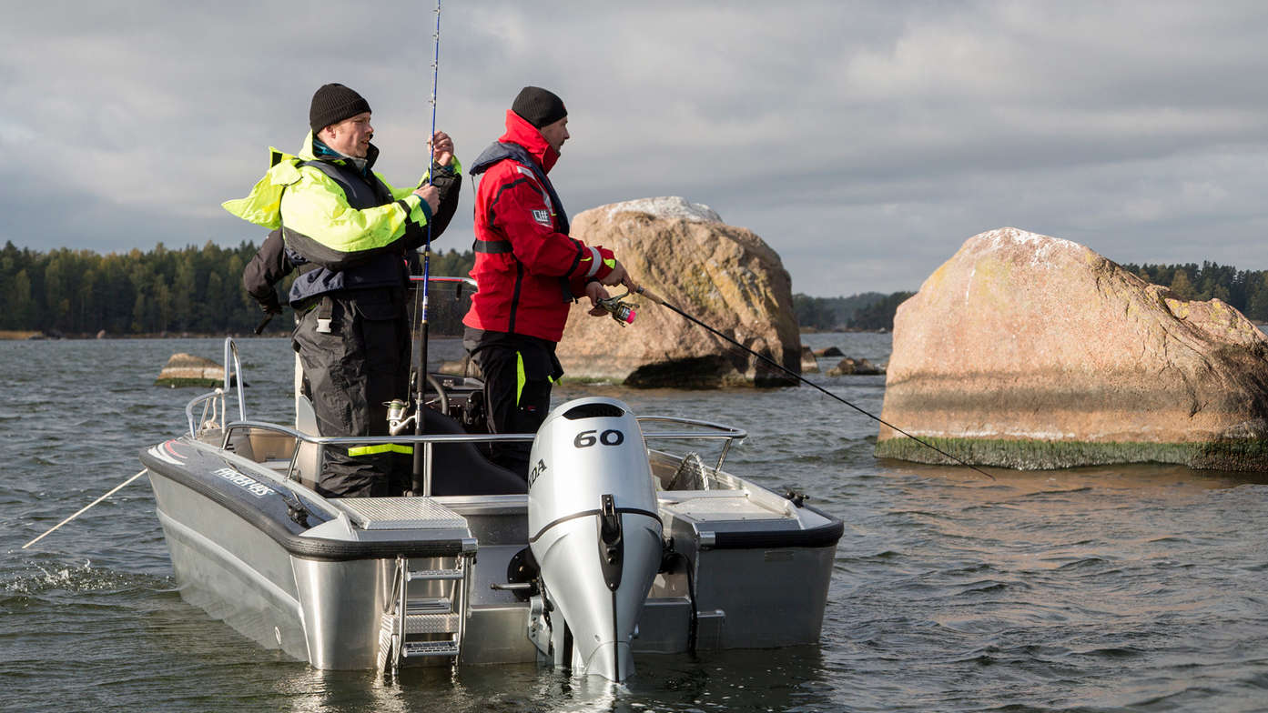 Boat using BF60 engine, being used by models, coastal location.