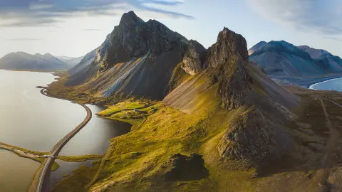 Toeristische weg in IJsland, prachtig natuurlandschap vanuit de lucht, bergen en kust bij zonsondergang