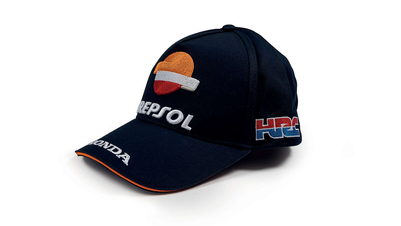 Blauwe pet met Honda MotoGP-teamkleuren en Repsol-logo.