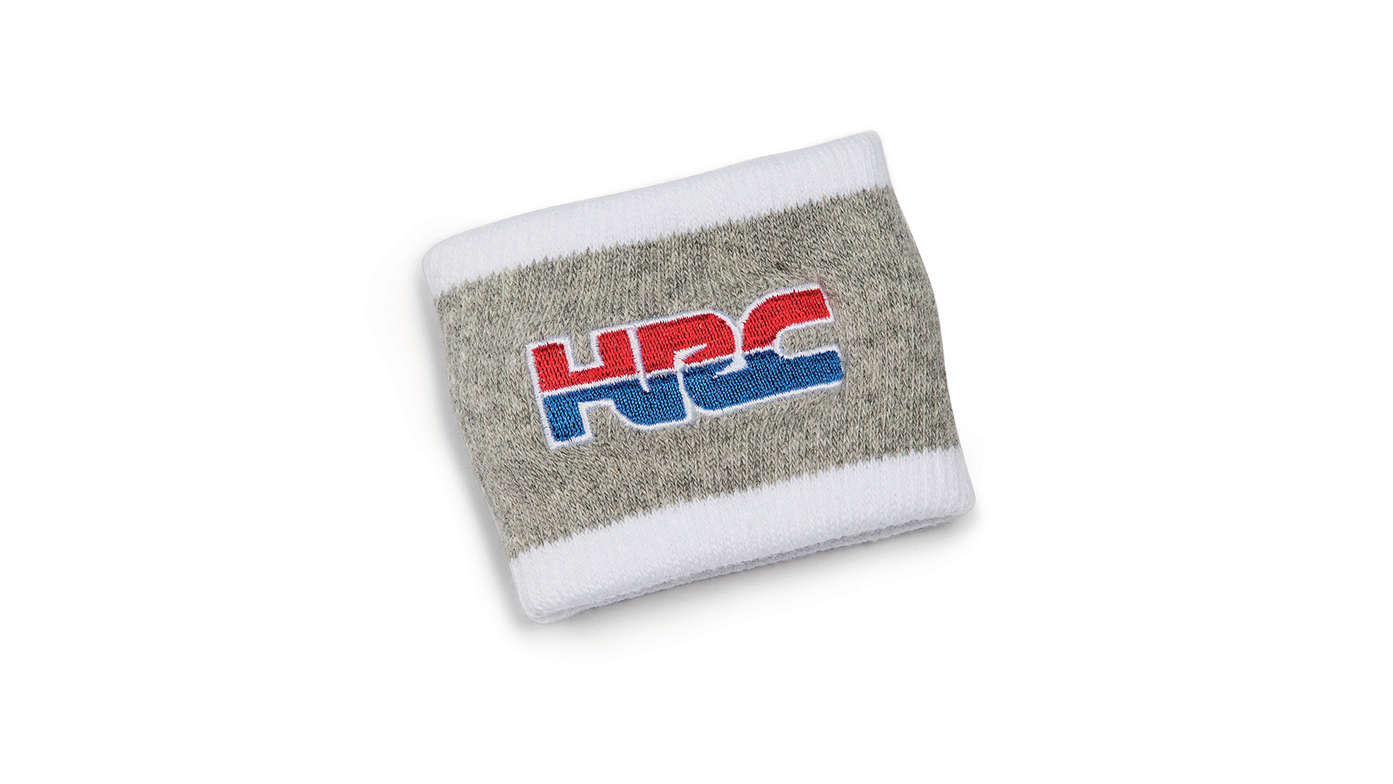 Grijze Honda HRC-polsband in HRC-kleuren met het Honda Racing Corporation logo.