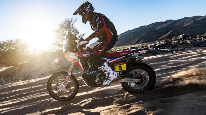 Linkerzijaanzicht van een Honda CRF450 door de zandduinen.